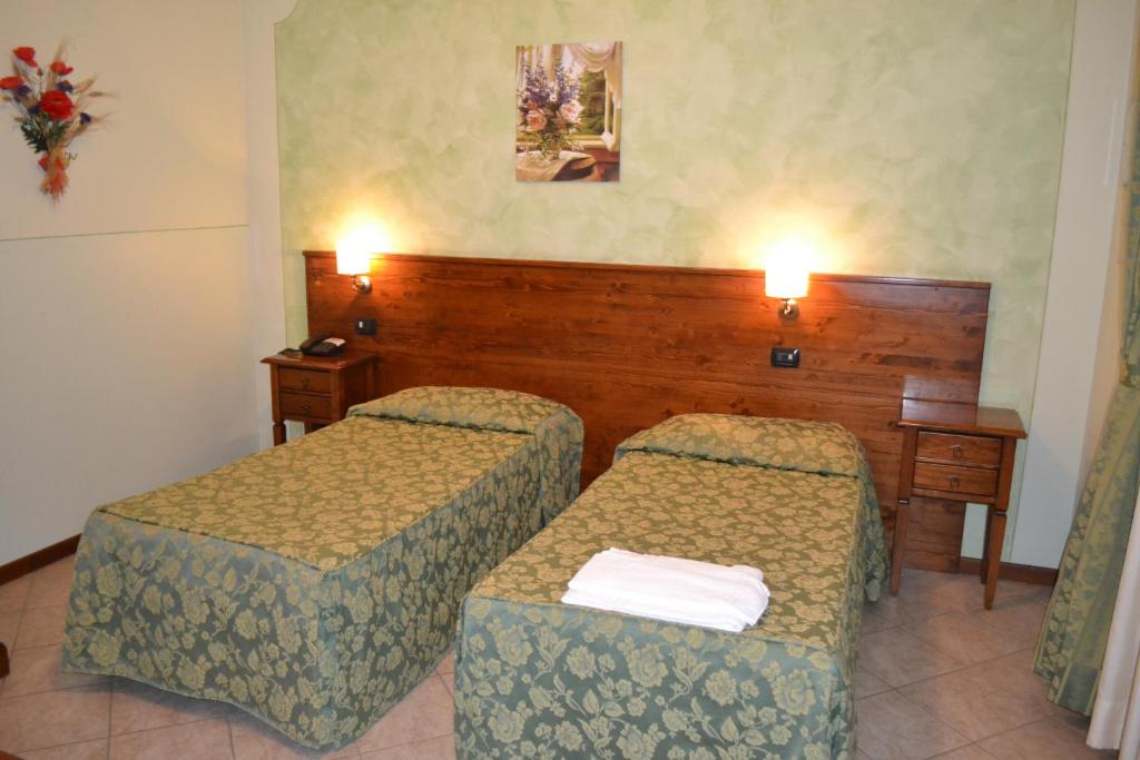 Postel nebo postele na pokoji v ubytování Albergo La Piana