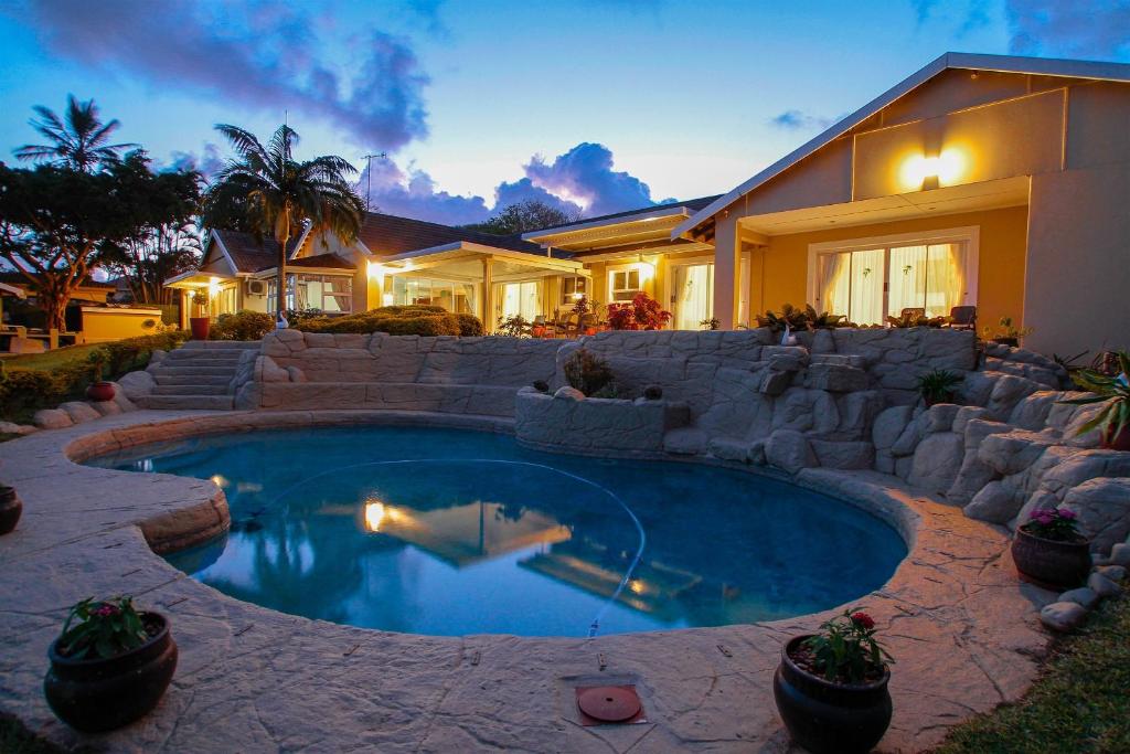 a swimming pool in front of a house at Addis Bed and Breakfast in Durban