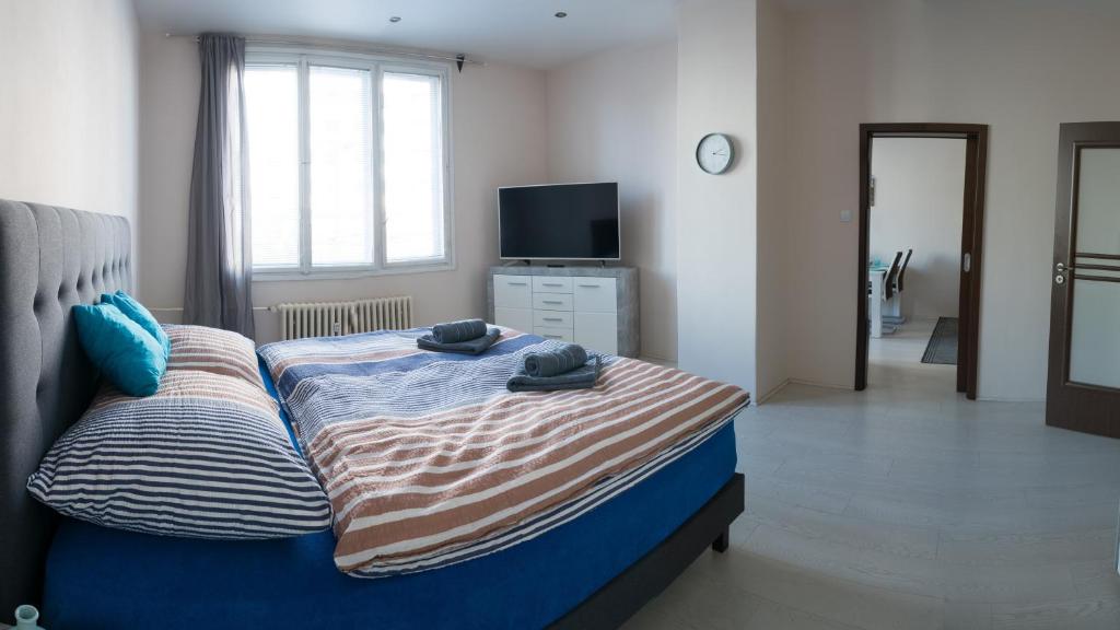 a bedroom with a bed with towels on it at Apartment Třída Míru in Pardubice