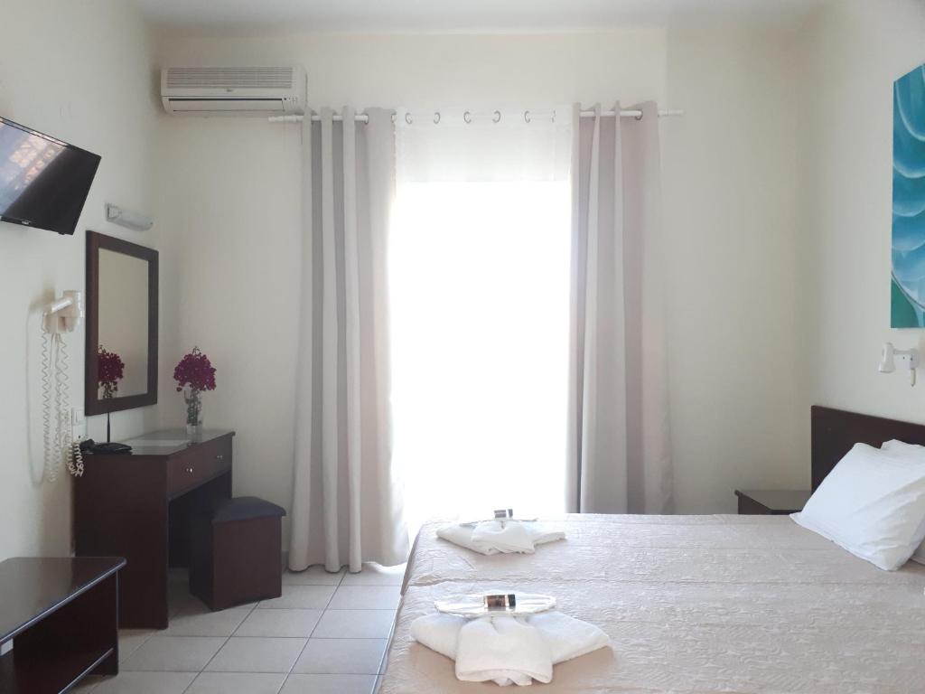 Postel nebo postele na pokoji v ubytování Metaxa Apartments