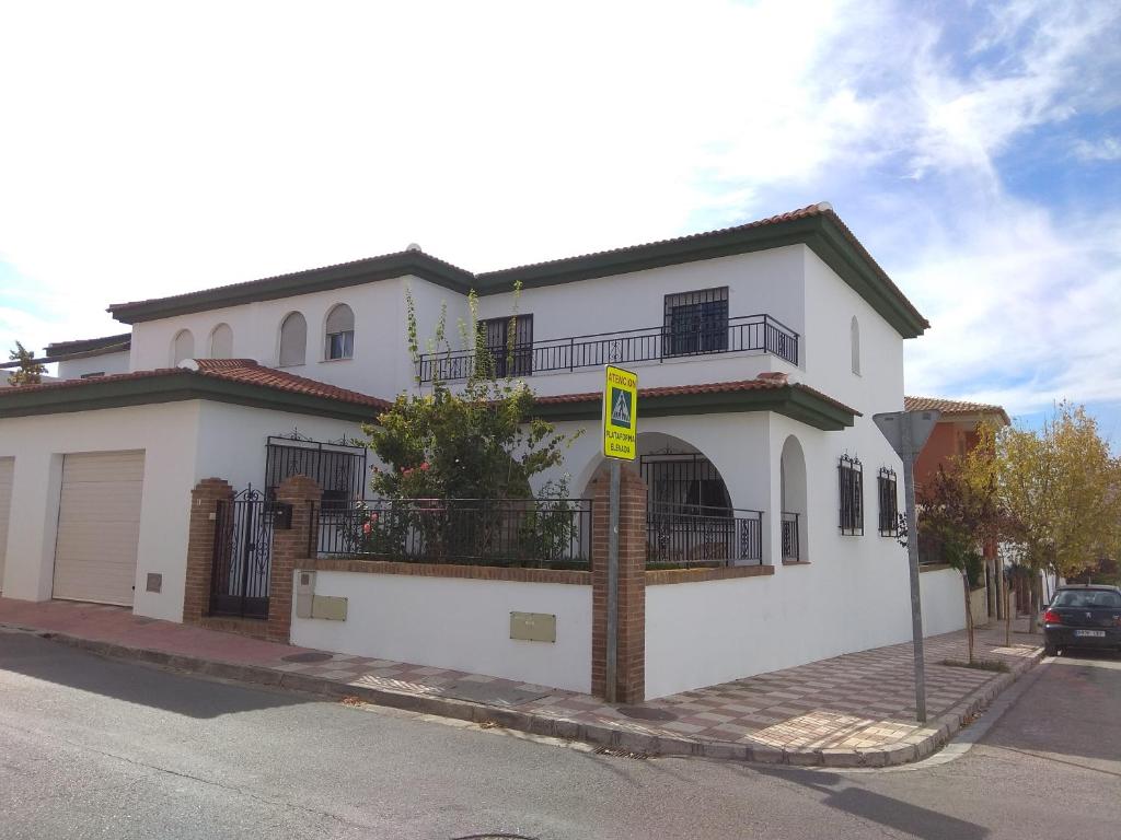 a white house on the side of a street at La casita de la abuela - Vivienda familiar con encanto in El Chaparral