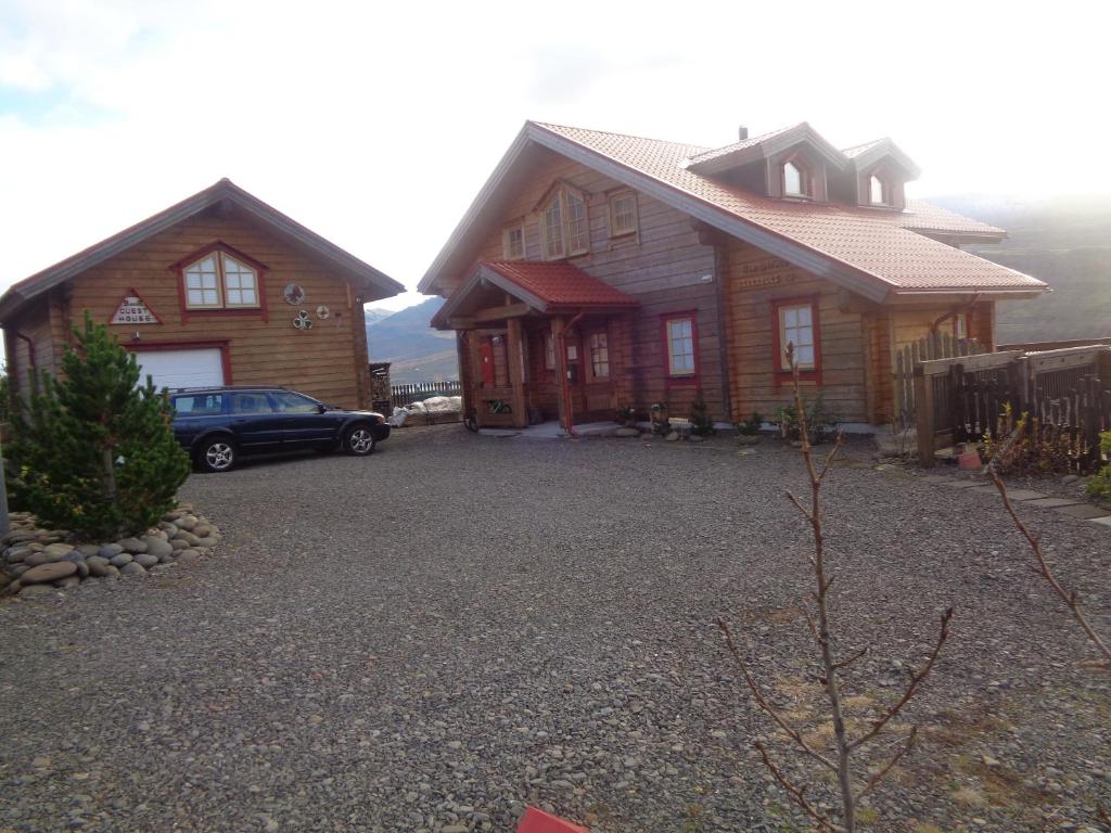 a house with a car parked in front of it at Family Home in Fáskrúðsfjörður
