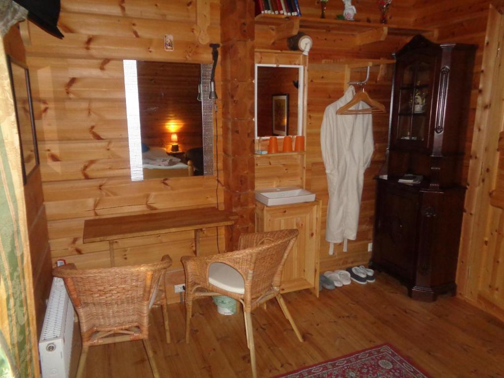 a room with a desk and chairs in a log cabin at Family Home in Fáskrúðsfjörður