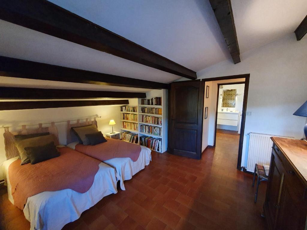 a bedroom with a large bed in a room at Les Chambres d&#39;Hôtes du Cladan in LʼÉpine