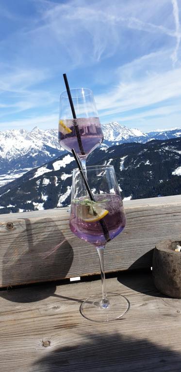 a drink in a wine glass sitting on a table at Ferienhaus Pöttler in Untertauern