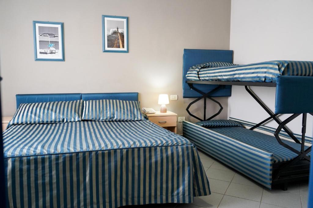 Postel nebo postele na pokoji v ubytování HG Hotel Il Settebello