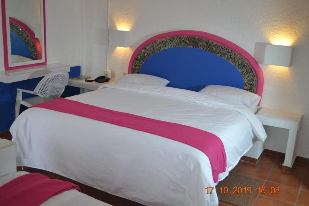 Postel nebo postele na pokoji v ubytování Hotel Pachuca Inn