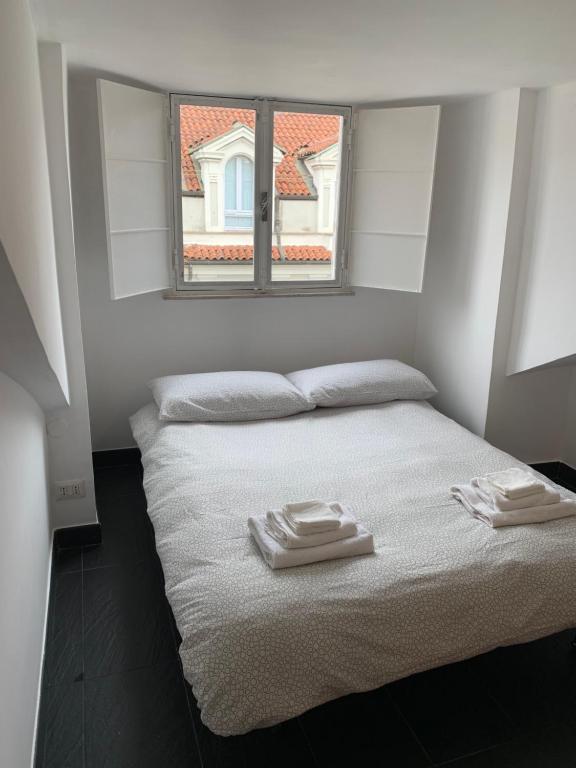 a bedroom with a bed with two towels on it at Mansarda Garibaldi 11 in Turin