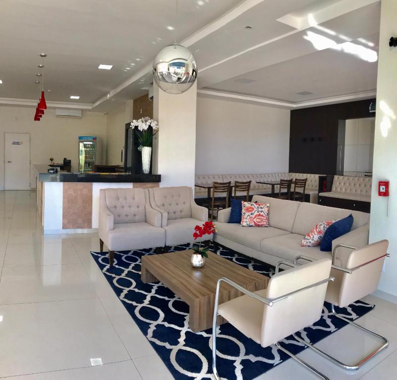 a living room with couches and a coffee table at Mac Hotel in Palmas