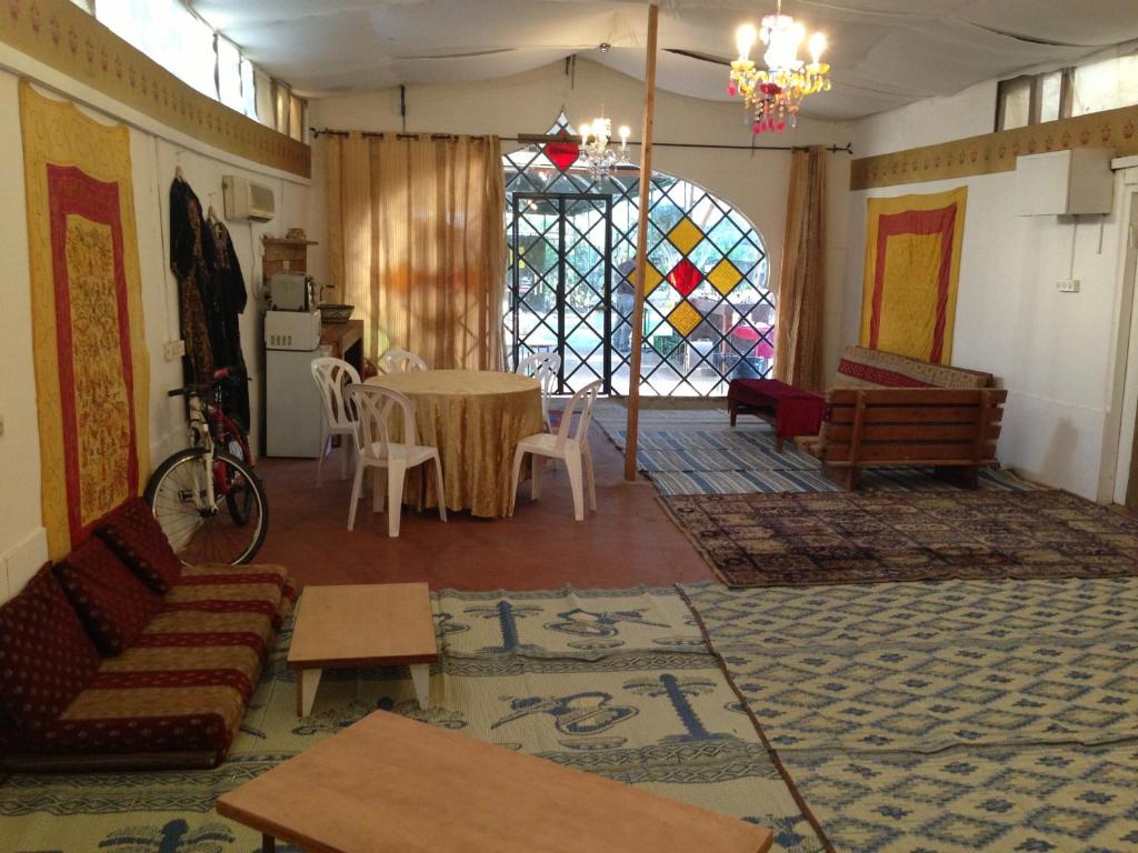 a living room with a table and a stained glass window at Peace Tent in Kfar Rut