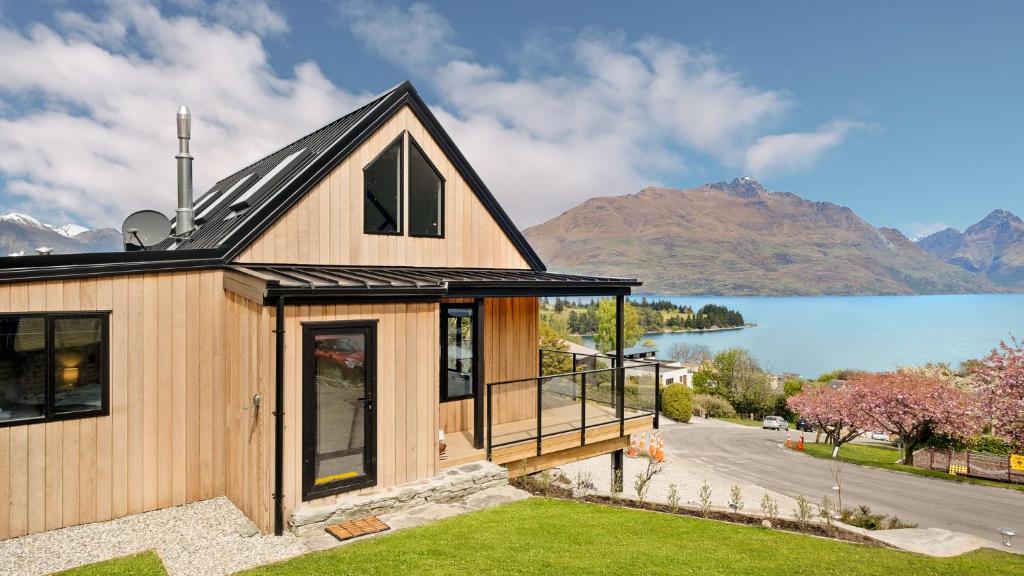 a house with a view of a lake and mountains at World Class Views in Queenstown