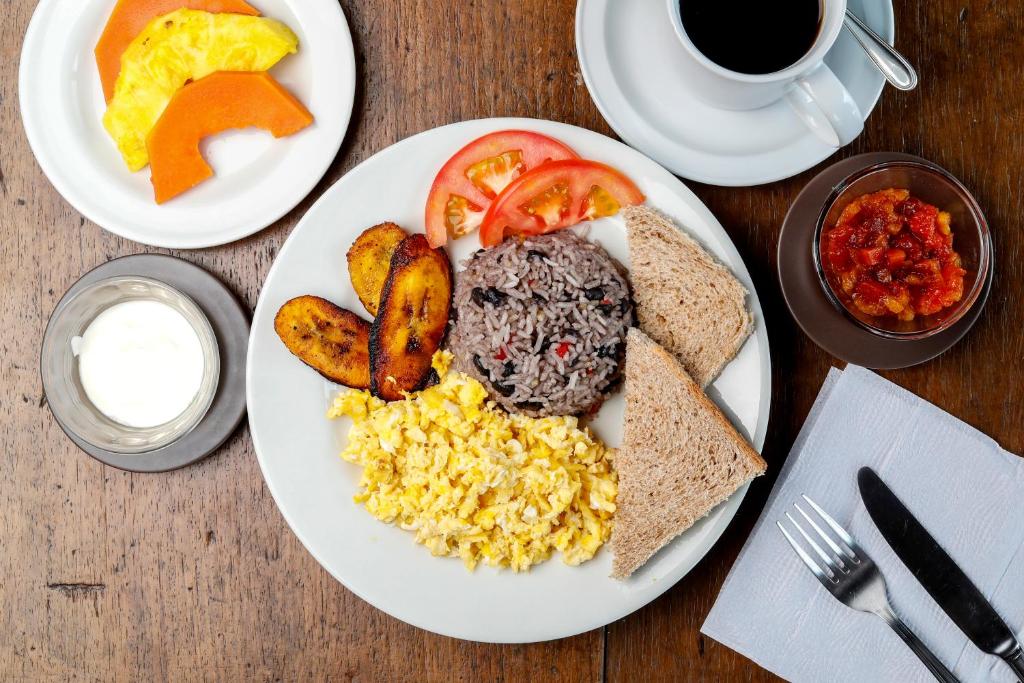a plate of breakfast food with eggs potatoes and toast at Casa Morella in Monteverde Costa Rica