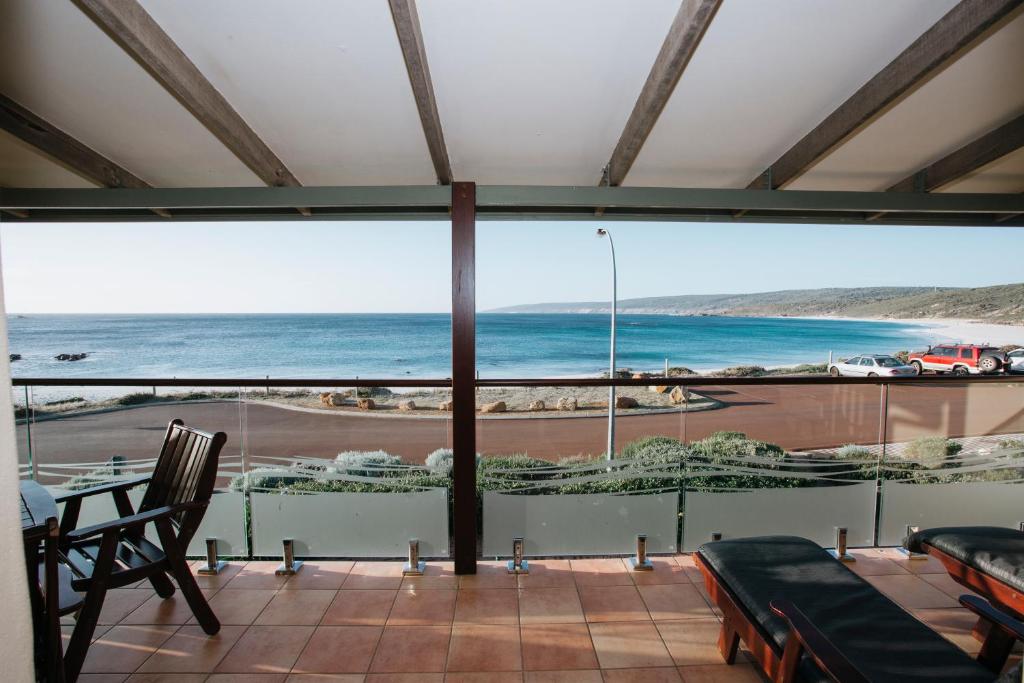 a balcony with a view of a beach and the ocean at Canal Rocks Beachfront Apartments in Yallingup