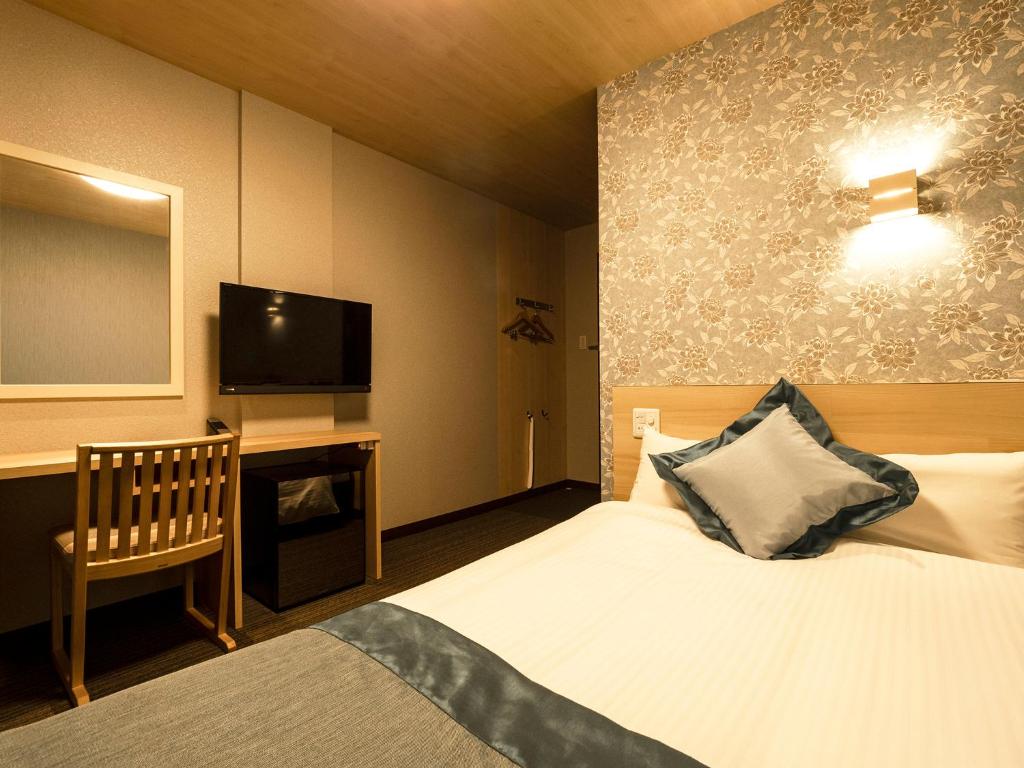 Postel nebo postele na pokoji v ubytování Hotel AreaOne Izumo