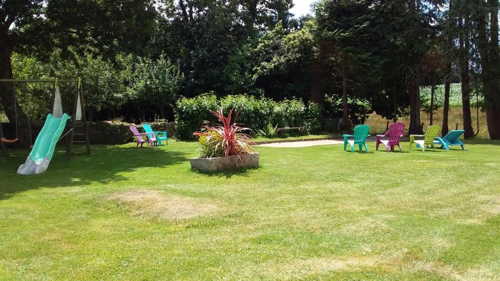a yard with colorful chairs and a swing at TY LOUISETTE in Bannalec