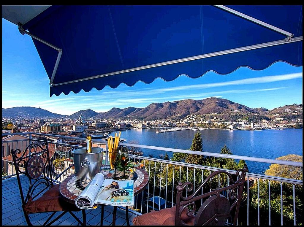 a balcony with a view of a body of water at Lo Specchio Sul Lago - The House Of Travelers in Como