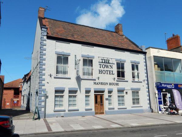 a white building on the corner of a street at The Town Hotel in Bridgwater