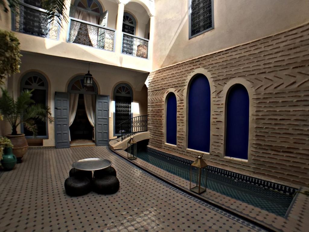 a building with a table in the middle of a courtyard at Riad Bel Haj in Marrakesh