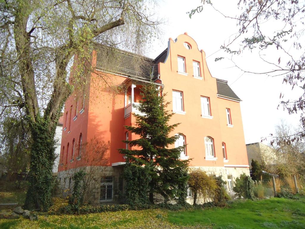 a large building with a tree in front of it at Georgentor in Naumburg