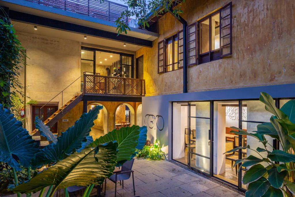 an exterior view of a house with a patio at The Postcard Mandalay Hall, Kochi in Cochin