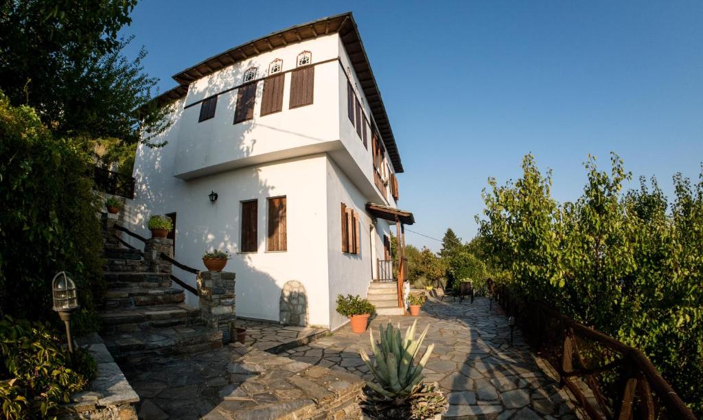 a white house with stairs and trees at Pelion House with Wonderful View in Vizitsa