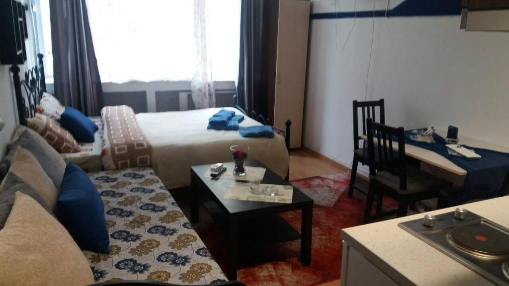 a hotel room with a bed and a table and a desk at Ano Ladadika in Thessaloniki