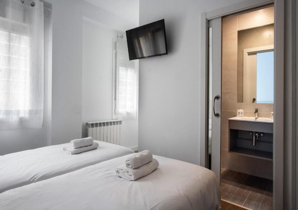 Cama o camas de una habitación en Hostal Lar