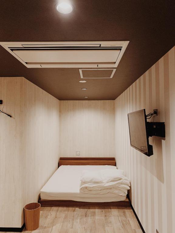 Postel nebo postele na pokoji v ubytování Hotel Capsule Inn Shizuoka