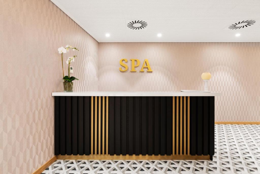 a lobby with a spa sign on the wall at Eurostars Matosinhos in Matosinhos