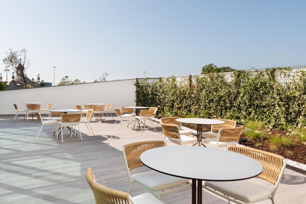 a group of tables and chairs on a patio at Eurostars Matosinhos in Matosinhos