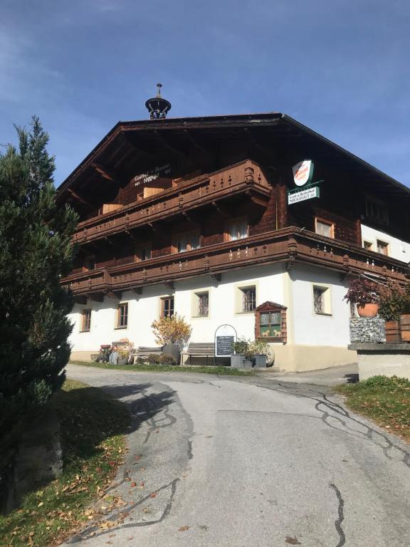 a large white building with a black roof at Reiterhof Nigglgut in Bucheben