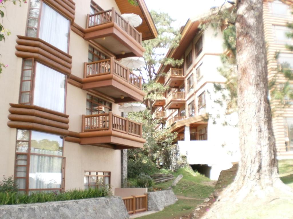 a building with balconies on the side of it at PRIVATE suite AT CAMP JOHN HAY FOREST LODGE in Camp John Hay