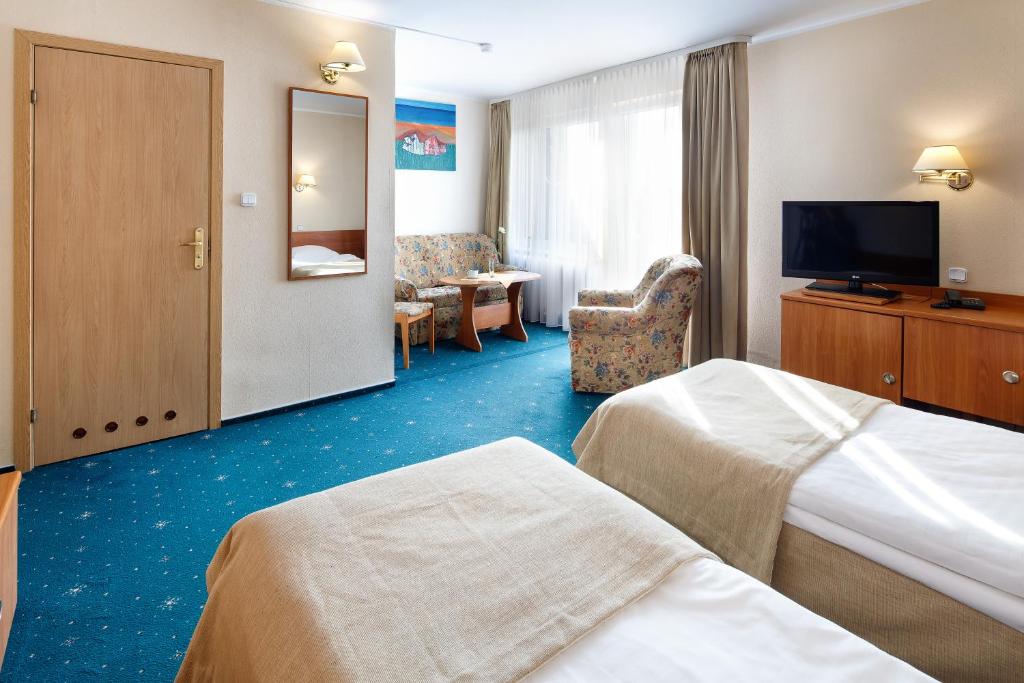 Postel nebo postele na pokoji v ubytování Hotel Wodnik
