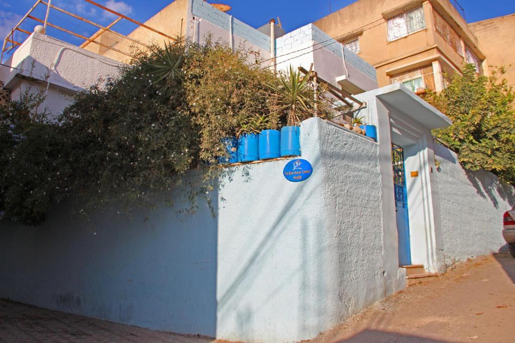 a white fence with plants on top of it at The Blue House "Gerasa" in Jerash