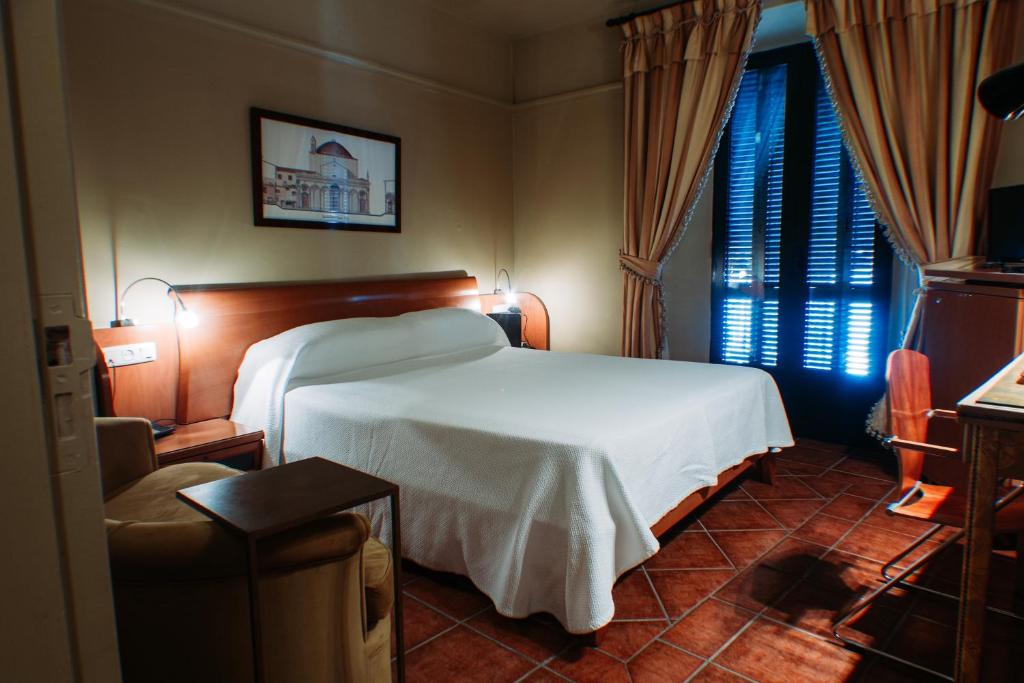 Postel nebo postele na pokoji v ubytování Hotel Carabeo