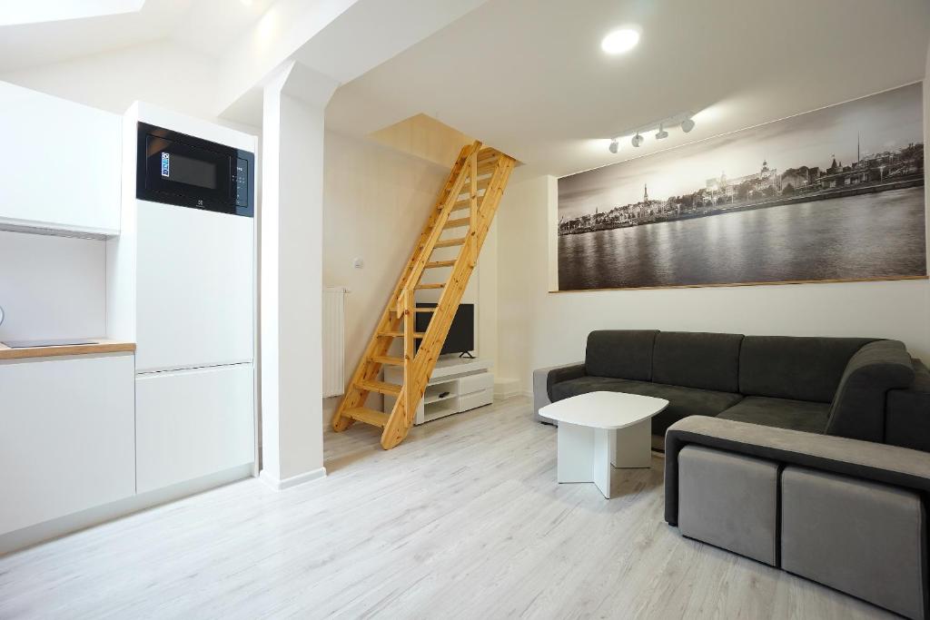 a living room with a couch and a ladder at Viking Home: Apartament Joanna in Szczecin