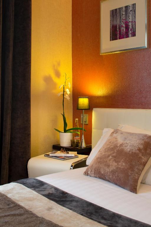 Postel nebo postele na pokoji v ubytování Hotel des Arceaux