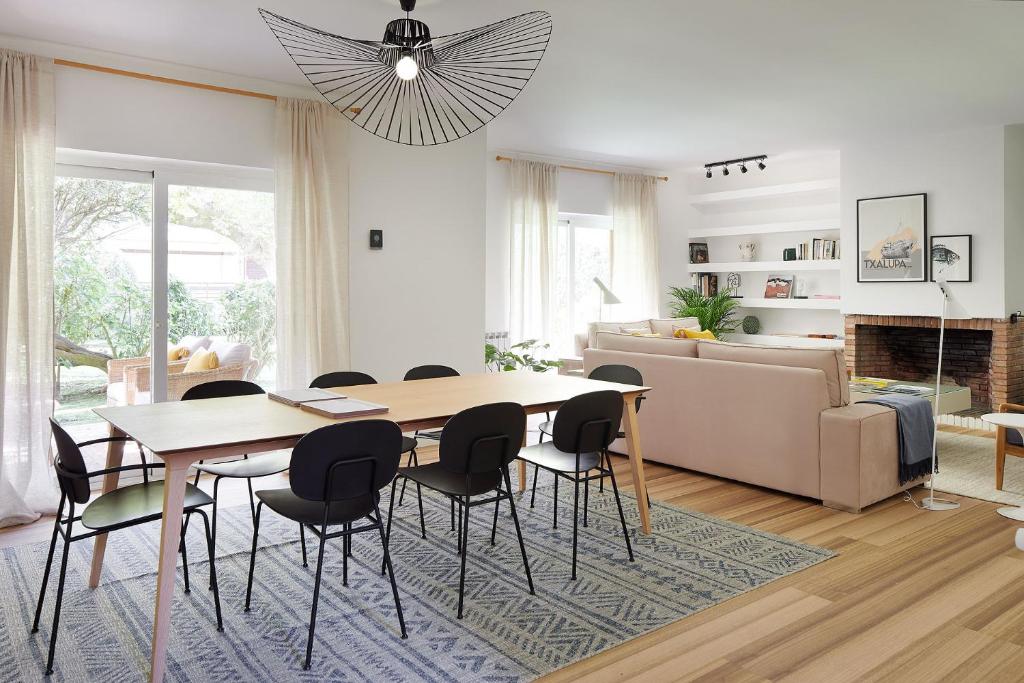 a living room with a dining room table and chairs at ATeRIAN VILLA ARESTI in Zarautz