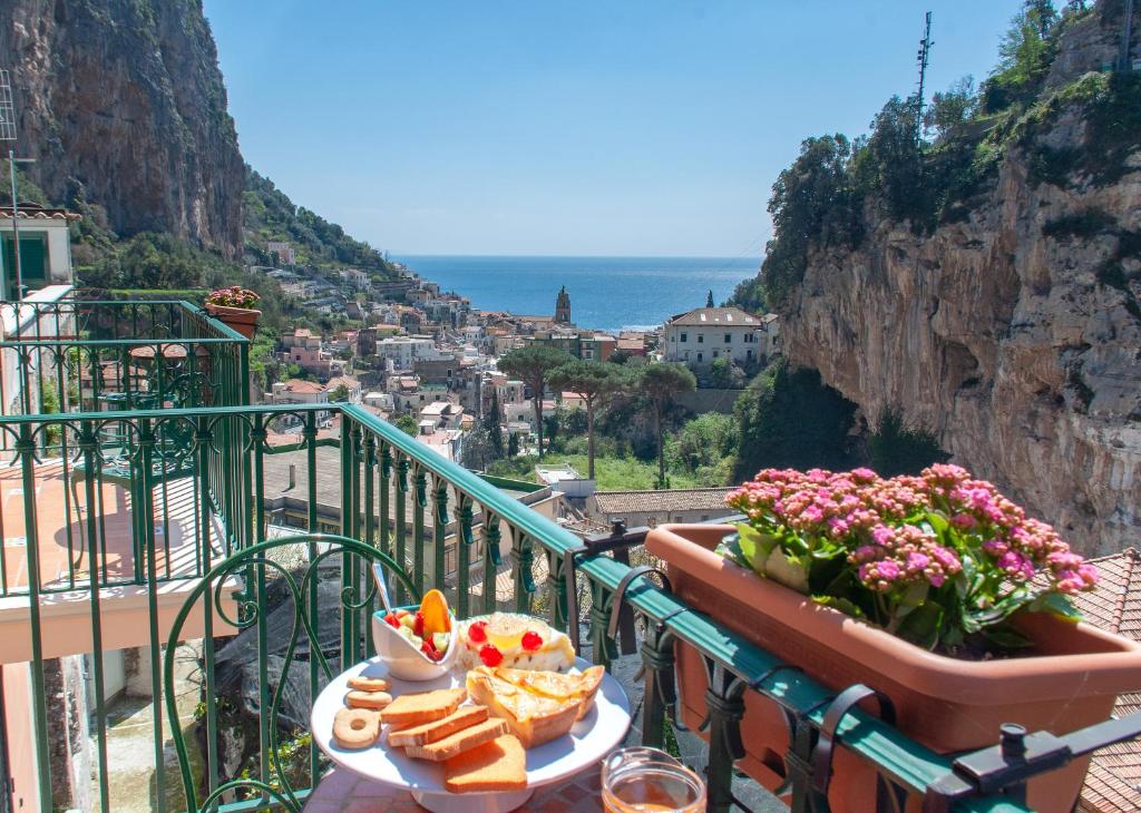 einen Balkon mit einem Tisch mit Brot und Aussicht in der Unterkunft La Valle Delle Ferriere in Amalfi