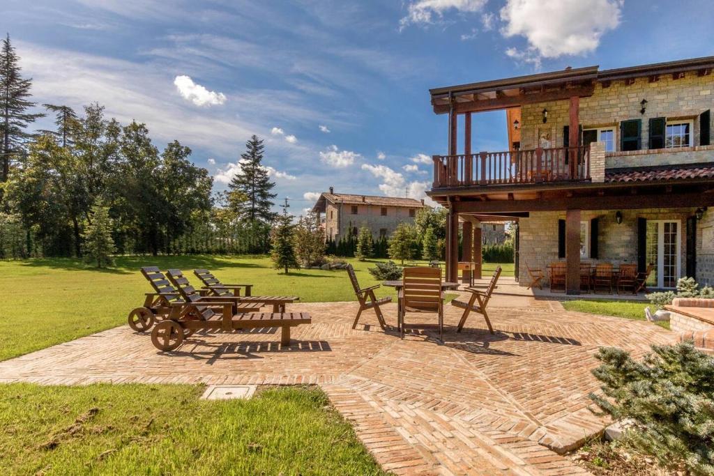 a group of chairs and tables on a patio at ALTIDO Superb Villa with Tennis Court, Garden and BBQ area in Valle