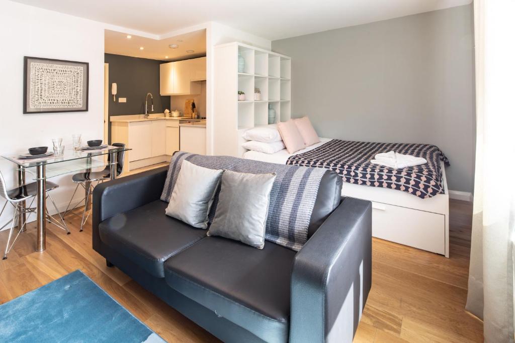 a living room with a couch and a bed at Alison Court in Bristol