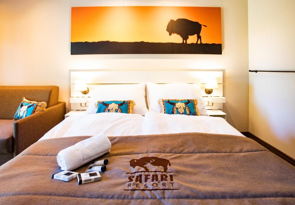 a hotel room with a bed with a blanket on it at Residence Safari Resort - Bison Lodge in Borovany