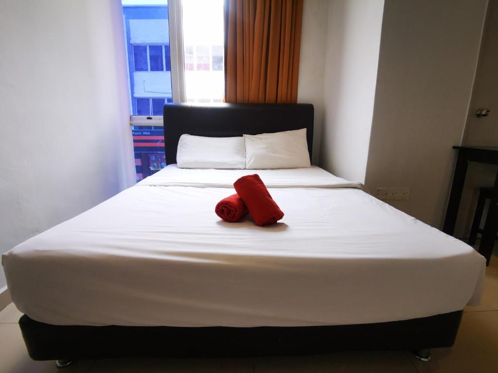 Postel nebo postele na pokoji v ubytování Clover Hotel Port Dickson
