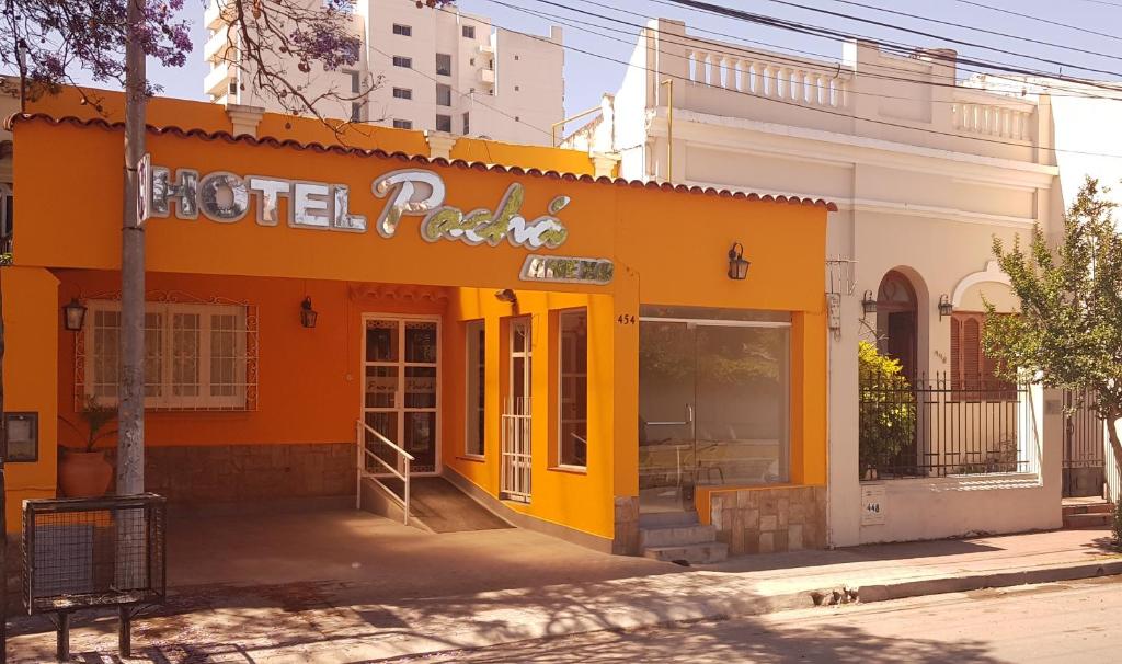 an orange building with a sign on the side of it at Hotel Pachá Anexo in Salta
