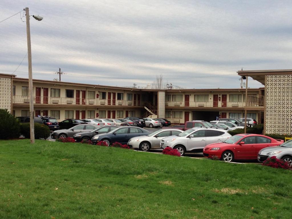 a parking lot with cars parked in front of a building at Campus Inn in Lafayette