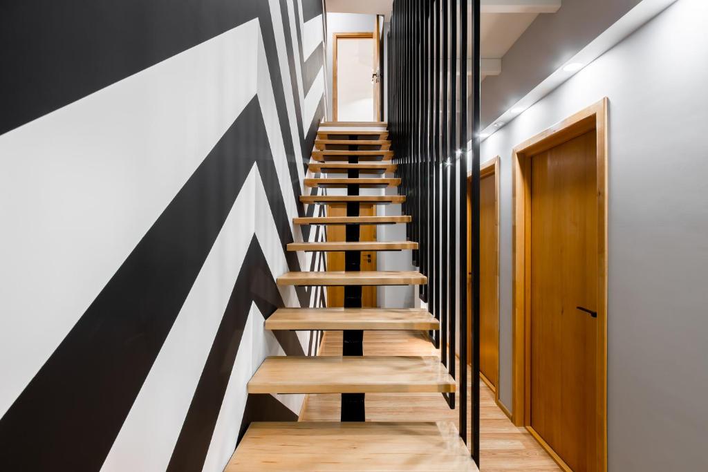 a staircase in a house with black and white stripes at Roof Rooms in Ivano-Frankivsʼk