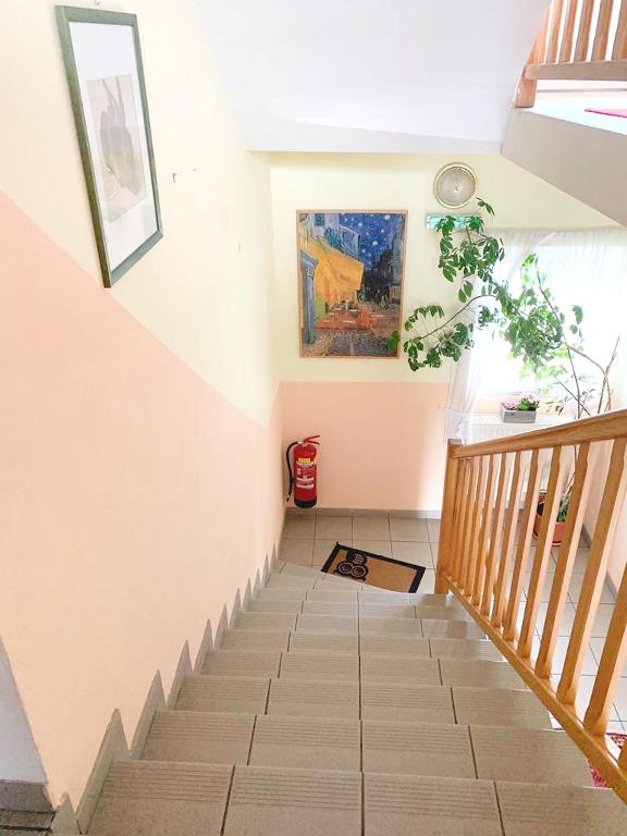 a staircase in a house with a painting on the wall at Pension Huber in Klosterneuburg