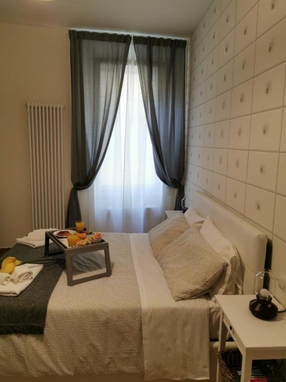 a bedroom with a bed with a table on it at Residenza Rialto in Bologna