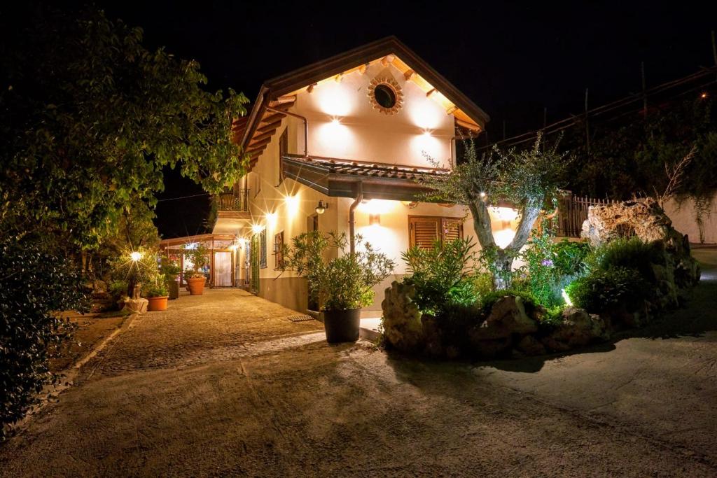 a house with lights on the side of it at night at Agriturismo Mare e Monti in Agerola