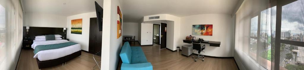 Postel nebo postele na pokoji v ubytování Hotel Dann Cali